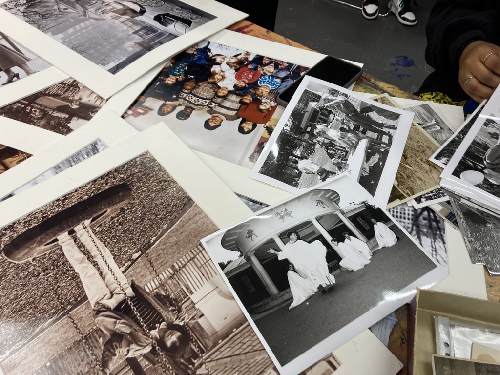photo of a number of archival photos of Coram's Fields spread across a table